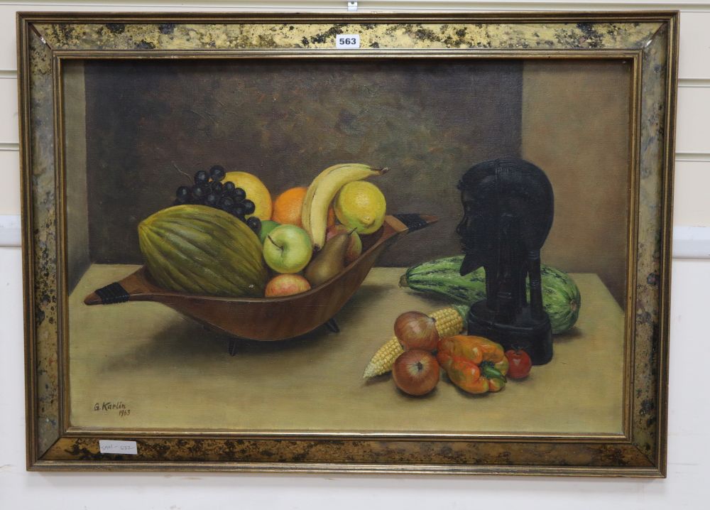 G. Karlin, oil on canvas, Still life of fruit and an African bust on a table top, signed and dated 1963, 50 x 75cm